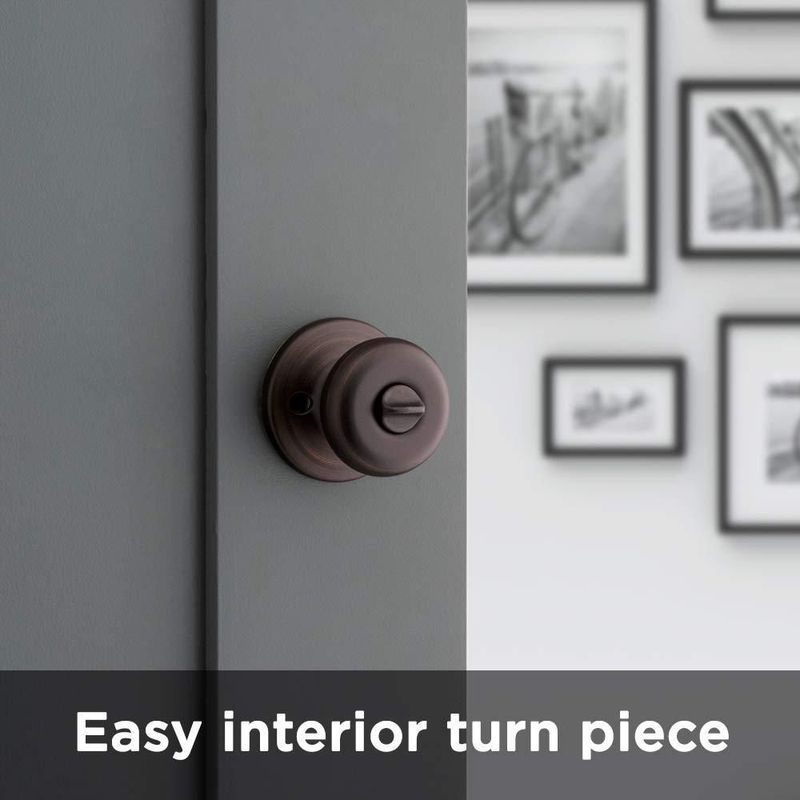 Pomo de puerta Kwikset Juno Interior Privacy con cerradura en bronce veneciano